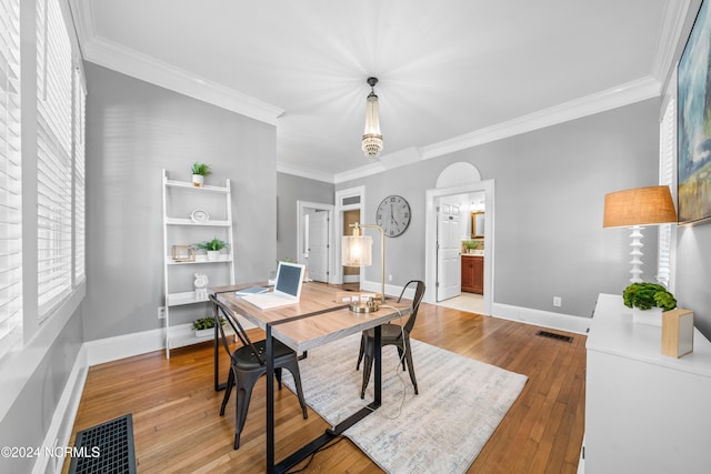 dining room with light hardwood / wood-style floors and ornamental molding