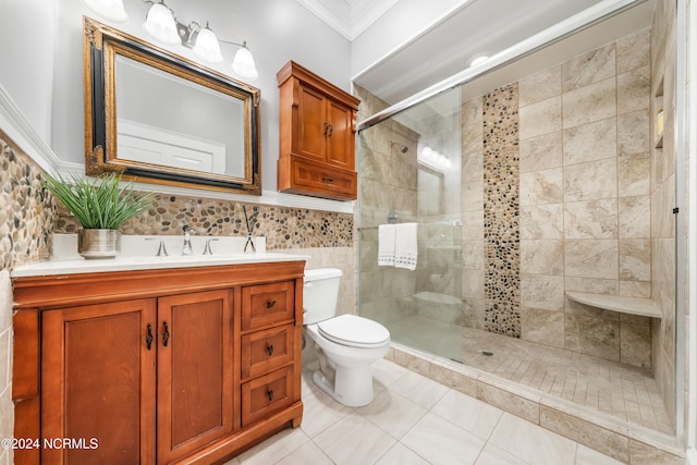 bathroom featuring tile patterned flooring, toilet, a shower with door, vanity, and ornamental molding