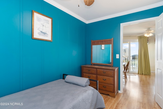 bedroom with ceiling fan, light hardwood / wood-style floors, and ornamental molding