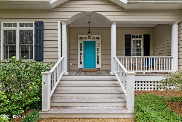 view of exterior entry featuring a porch