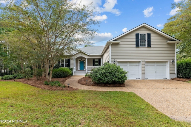 view of front facade featuring covered porch, a garage, and a front yard