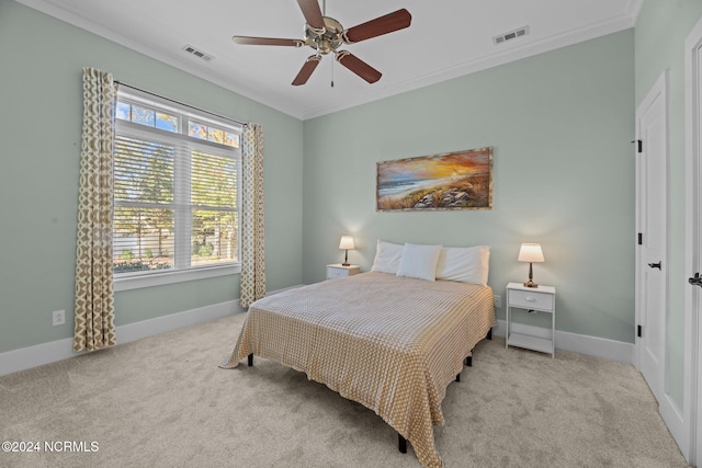 bedroom featuring ceiling fan, light colored carpet, and crown molding