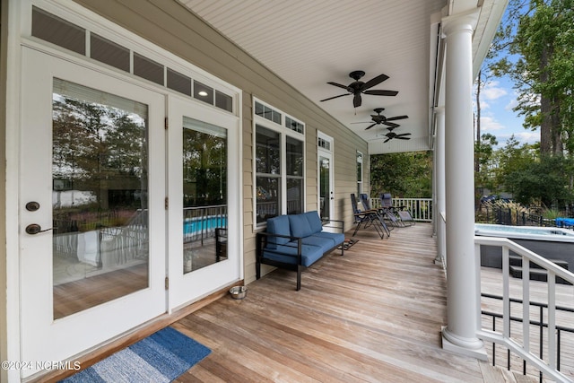 wooden terrace featuring ceiling fan and covered porch