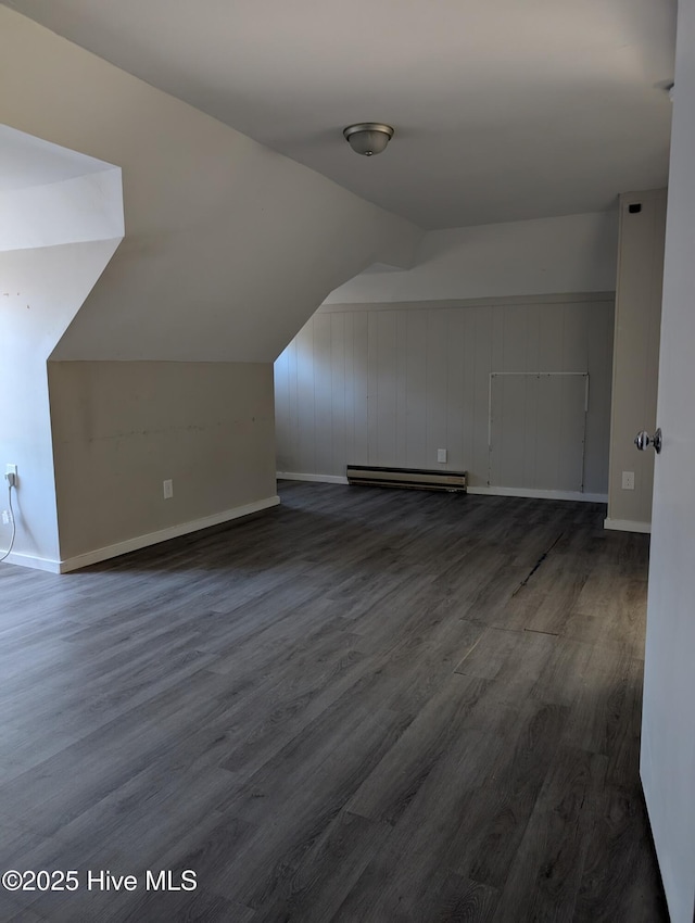 bonus room featuring a baseboard radiator, vaulted ceiling, and dark wood-type flooring