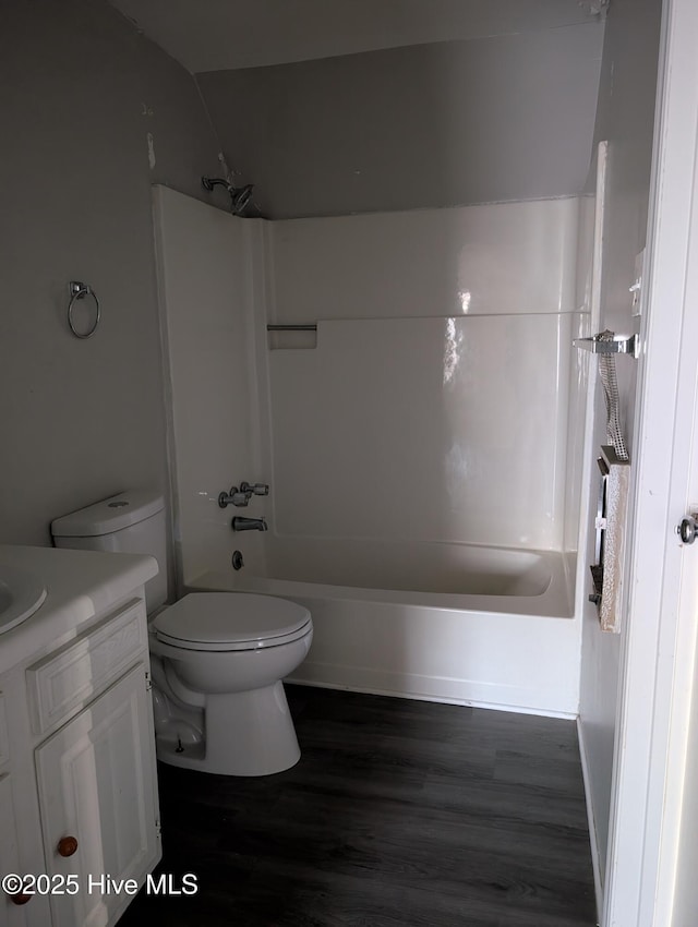 full bathroom featuring hardwood / wood-style flooring, vanity, toilet, and bathing tub / shower combination