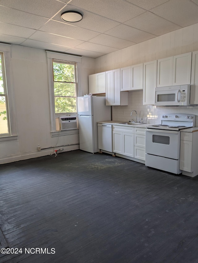 kitchen featuring white cabinetry, plenty of natural light, sink, and white appliances