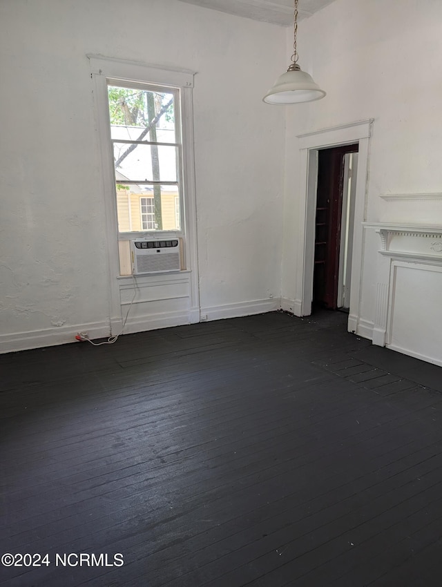 spare room with cooling unit and dark hardwood / wood-style flooring