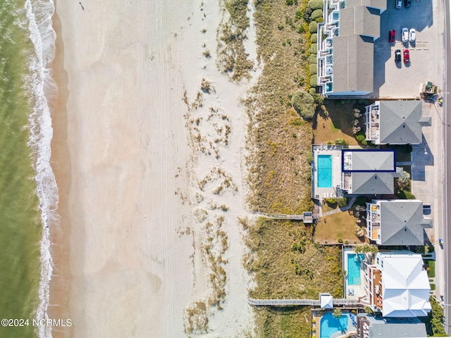 drone / aerial view featuring a water view and a view of the beach