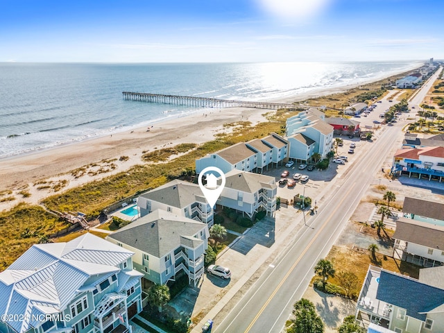 drone / aerial view with a water view and a beach view