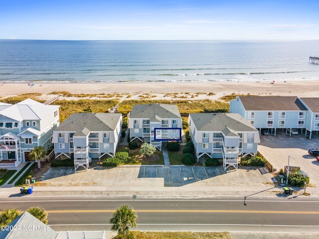 birds eye view of property with a water view and a view of the beach