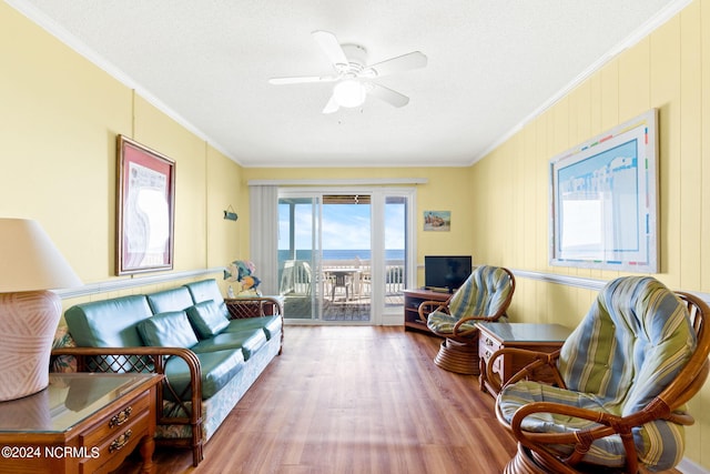 living room with hardwood / wood-style floors, crown molding, a textured ceiling, and ceiling fan