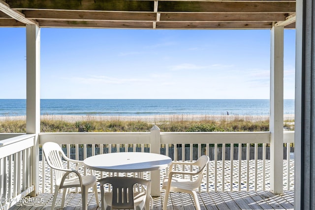 balcony with a water view and a beach view