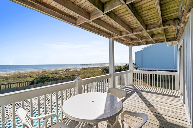 balcony featuring a water view and a beach view