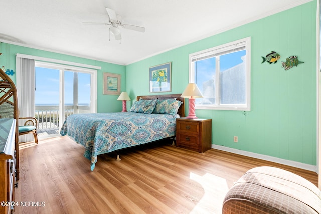 bedroom with access to outside, multiple windows, light hardwood / wood-style floors, and ceiling fan