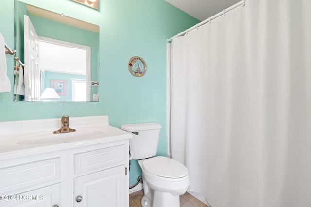 bathroom featuring vanity, toilet, and tile patterned floors