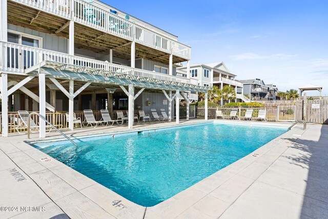 view of swimming pool with a patio and a deck