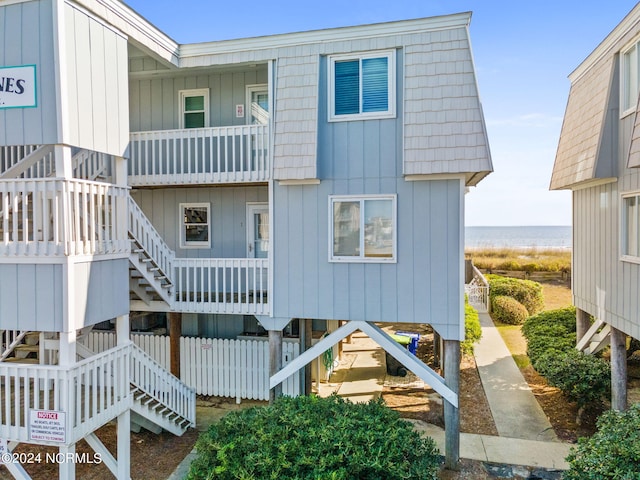 rear view of property with a water view