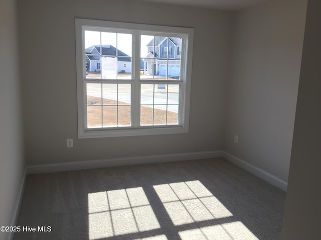 carpeted empty room with a healthy amount of sunlight