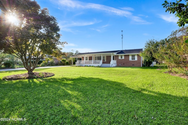 single story home with a front lawn and covered porch