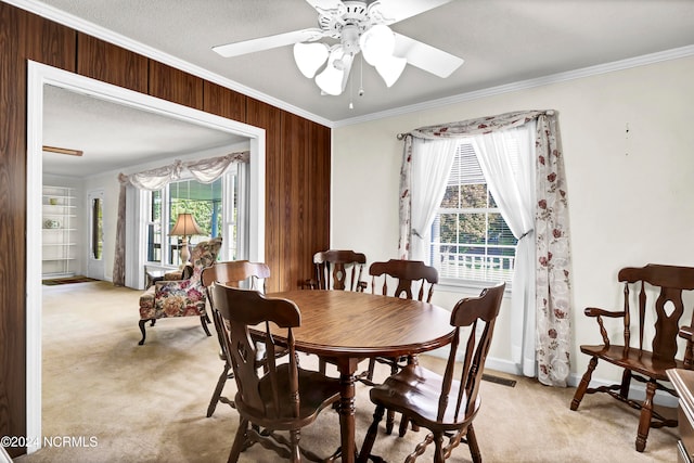 dining space with ceiling fan, a healthy amount of sunlight, and light colored carpet