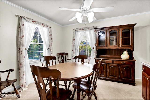 dining room featuring light colored carpet, plenty of natural light, and ceiling fan