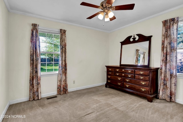 carpeted bedroom featuring crown molding and ceiling fan