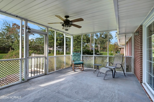 unfurnished sunroom with ceiling fan