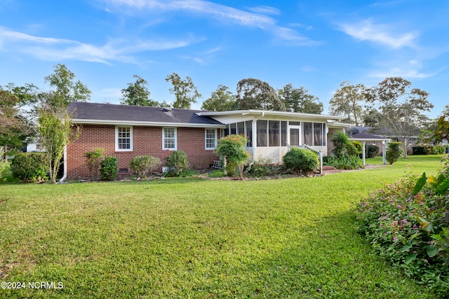 exterior space with a yard and a sunroom