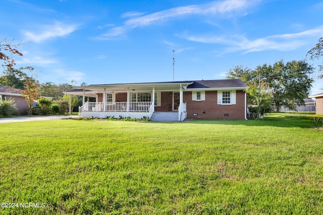 ranch-style home featuring covered porch and a front lawn