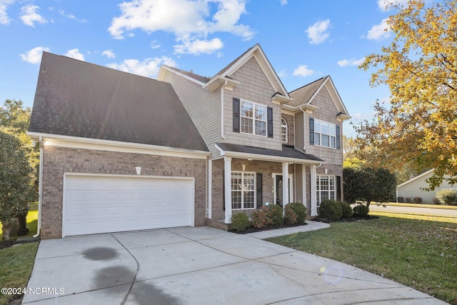 view of front of home featuring a garage and a front lawn