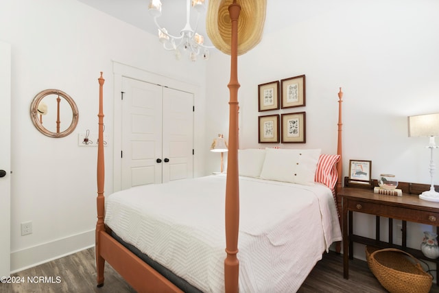 bedroom featuring dark hardwood / wood-style flooring and an inviting chandelier