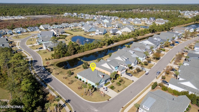 drone / aerial view featuring a residential view and a water view