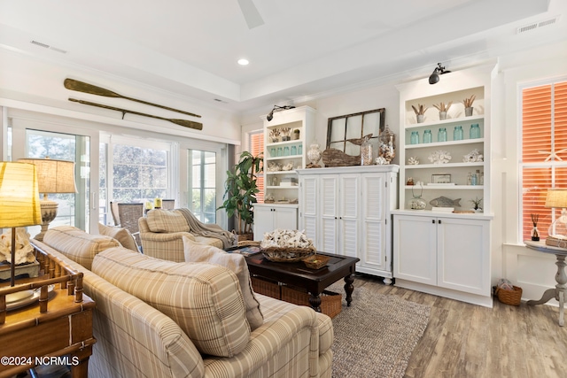 living area featuring recessed lighting, visible vents, and wood finished floors