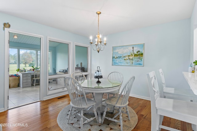 dining area featuring a chandelier and light hardwood / wood-style flooring