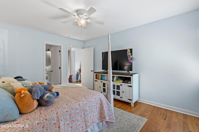 bedroom with connected bathroom, light wood-type flooring, and ceiling fan