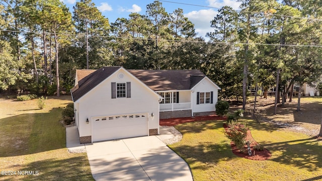 view of front of home with a garage, a front lawn, and a porch