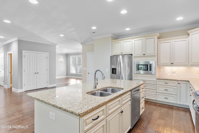 kitchen featuring dark wood-type flooring, stainless steel appliances, a center island with sink, sink, and light stone counters