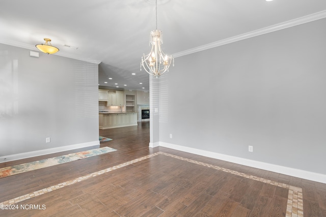 interior space featuring dark wood-type flooring, crown molding, and an inviting chandelier