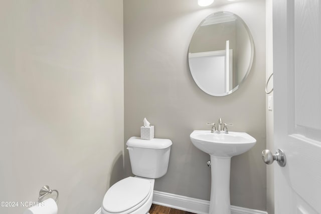 bathroom with toilet, hardwood / wood-style flooring, and sink