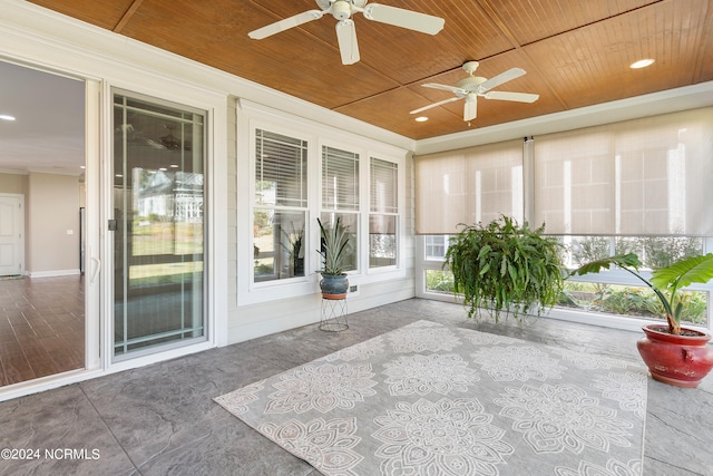 unfurnished sunroom with wooden ceiling and ceiling fan