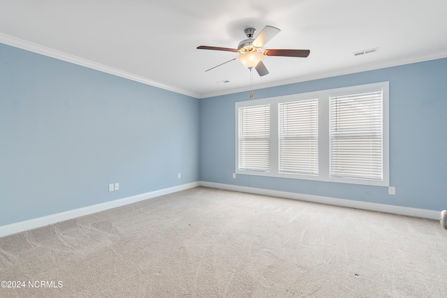 carpeted spare room with ornamental molding and ceiling fan