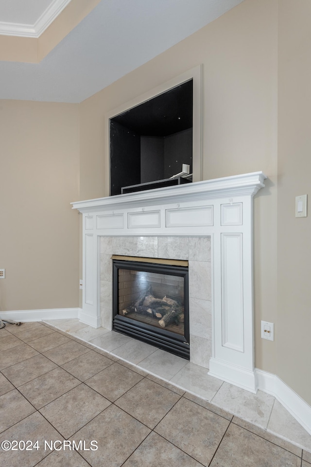 room details with ornamental molding, a tile fireplace, and tile patterned flooring