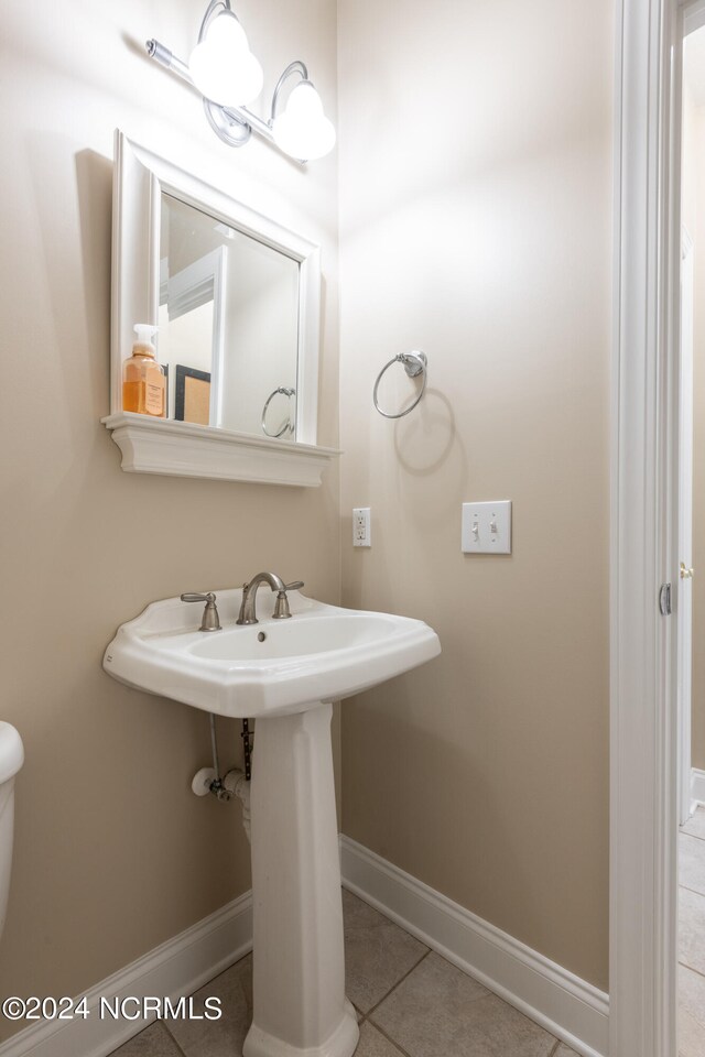 bathroom featuring tile patterned floors, sink, and toilet