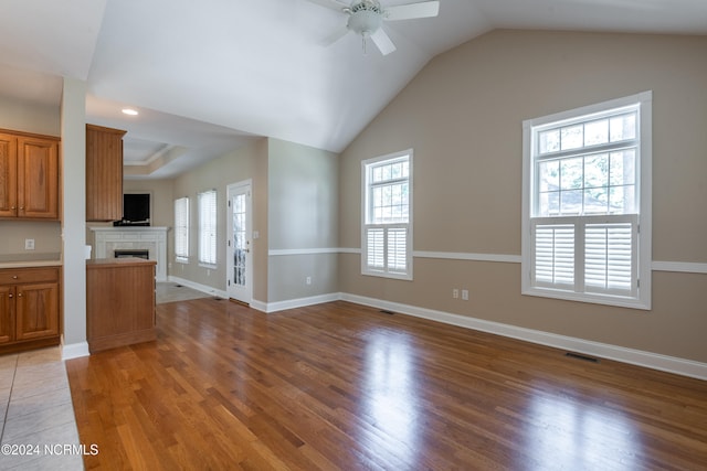 unfurnished living room with ceiling fan, a healthy amount of sunlight, and hardwood / wood-style floors