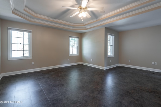 empty room featuring crown molding, ceiling fan, and a raised ceiling