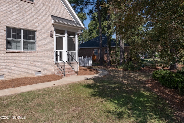 doorway to property with a lawn