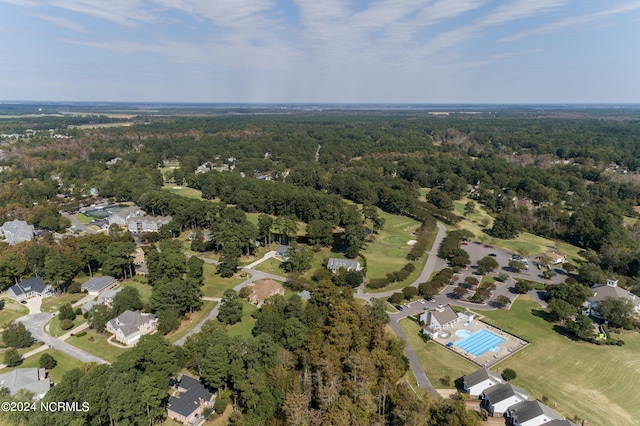 birds eye view of property featuring a wooded view
