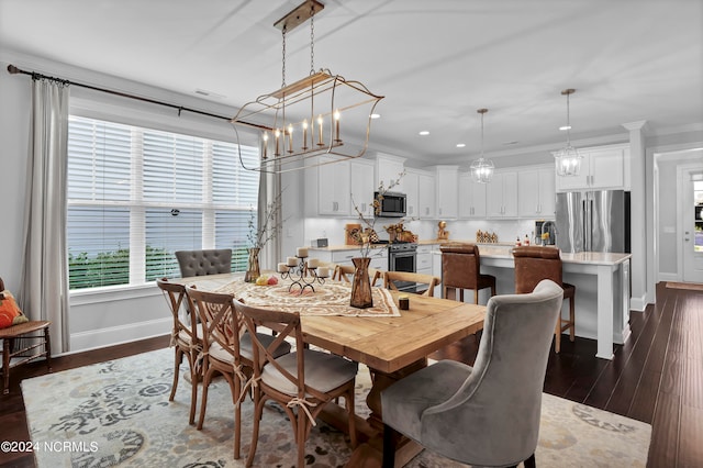 dining room featuring ornamental molding, a chandelier, and dark hardwood / wood-style floors