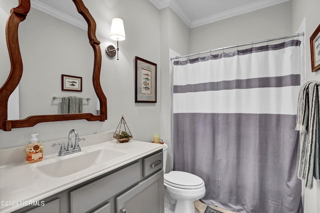 bathroom with vanity, toilet, and ornamental molding