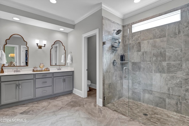 bathroom with vanity, toilet, ornamental molding, and an enclosed shower